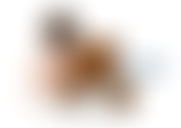 A diapered baby sits with a brown teddy bear on a white background. Text reads "Give a little, help a lot!" Mood is warm and comforting.