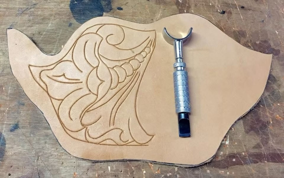 Carving the outline with a swivel knife