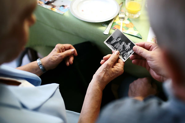 elderly couple looking at black and white photo