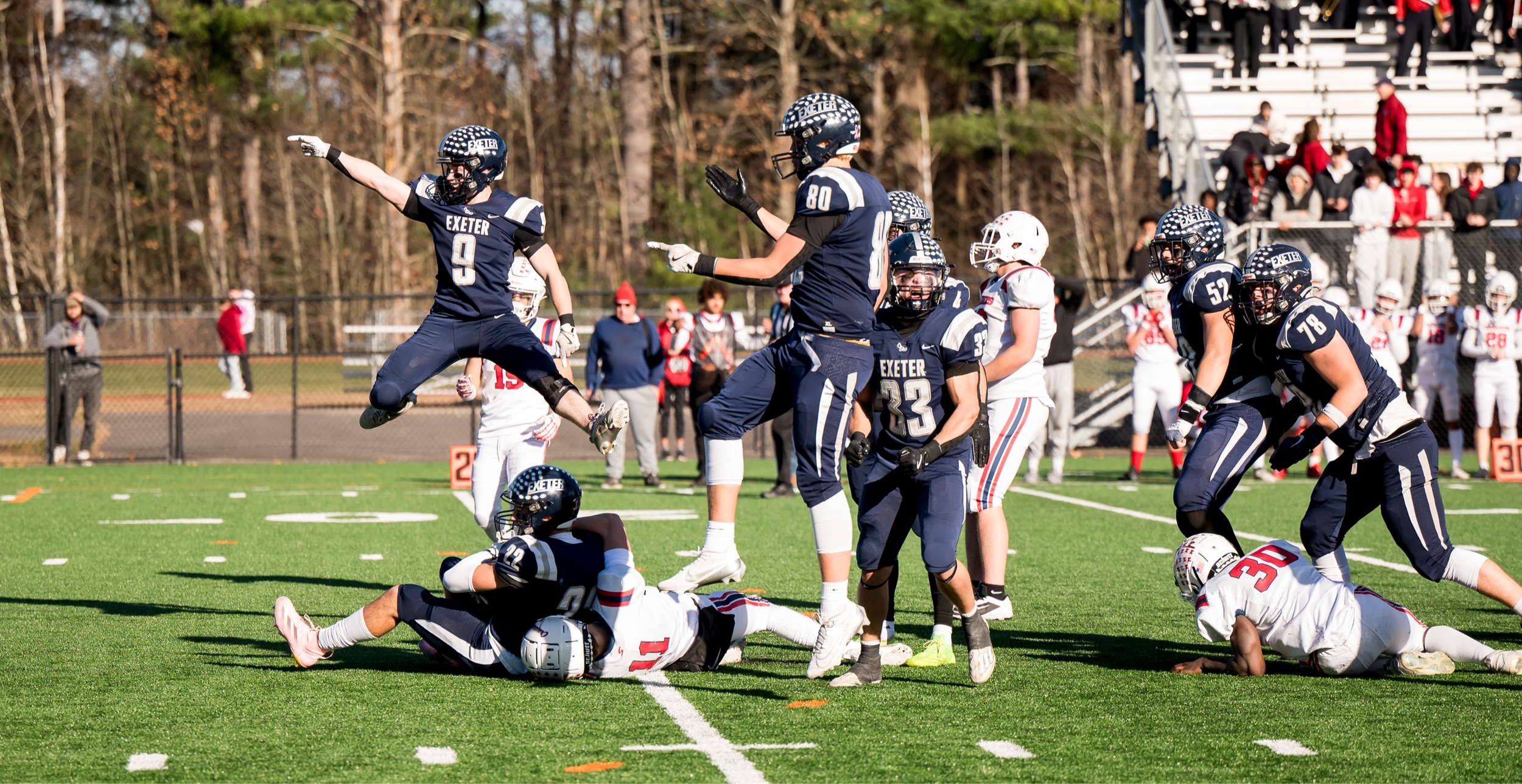 Exeter football players celebrating a great player during a game.