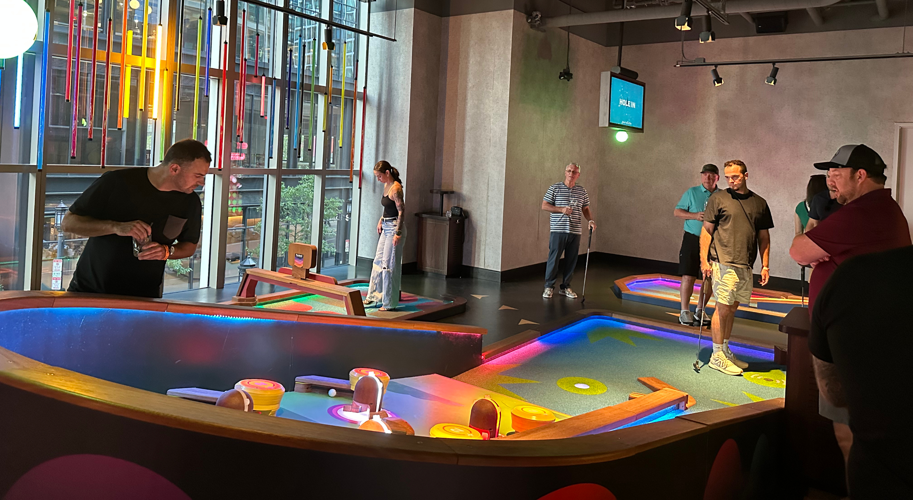 Gold Athletics employees enjoying time together playing mini golf at Puttshack in Boston, MA