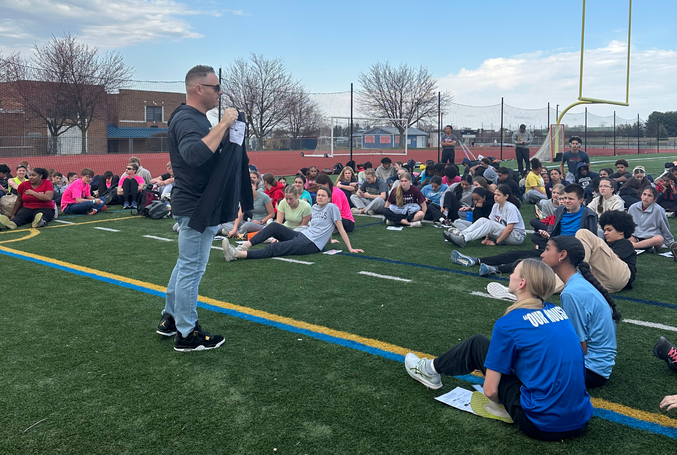 Fundraising Coach Brian Ludwig showing Conestoga Valley Track the prizes they can earn through the Gold Athletics fundraiser.