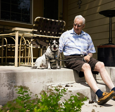 a man and his dog sitting together in the sun