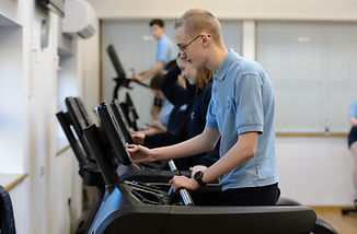 a young man using a treadmill in the gym
