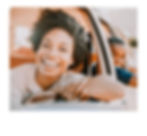 Smiling woman and child looking out of car window; Buddy's Carwash