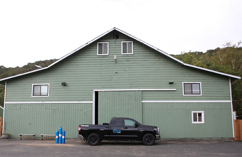 ANG truck in front of green barn