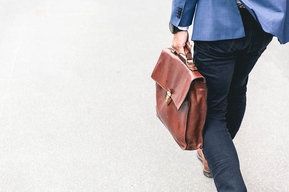 man holding handbag in color brown