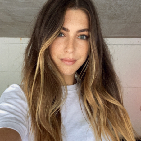 Beautiful green eyed woman with long natural hair with bits of brightness.