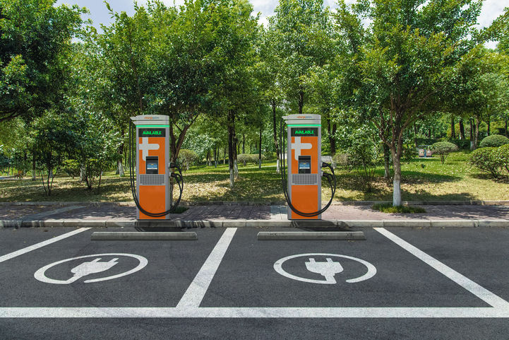 Two ChargePoint Express Plus stations in a tree-lined parking lot