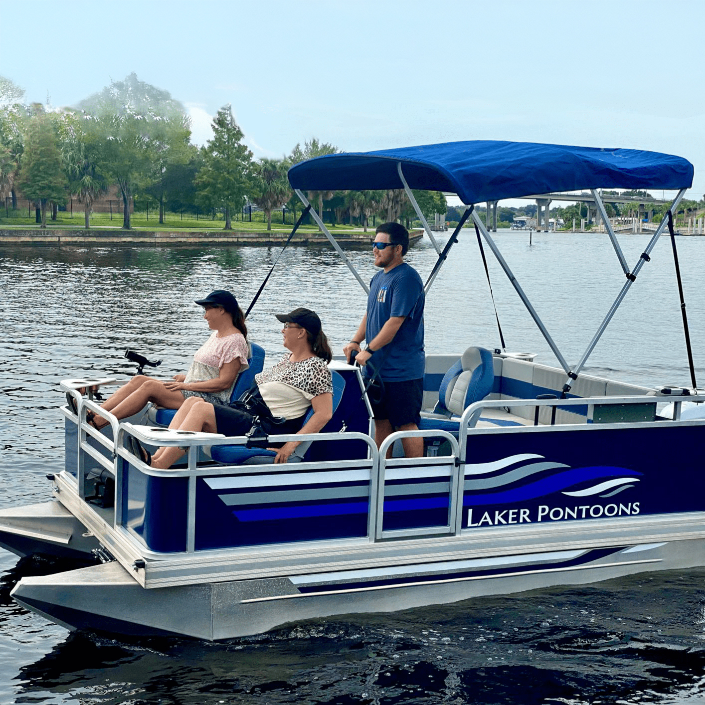 Family cruising on a blue Laker pontoon boat