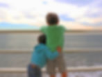 A close-up of two children holding hands, illustrating the lifelong bond of siblings through adoption.