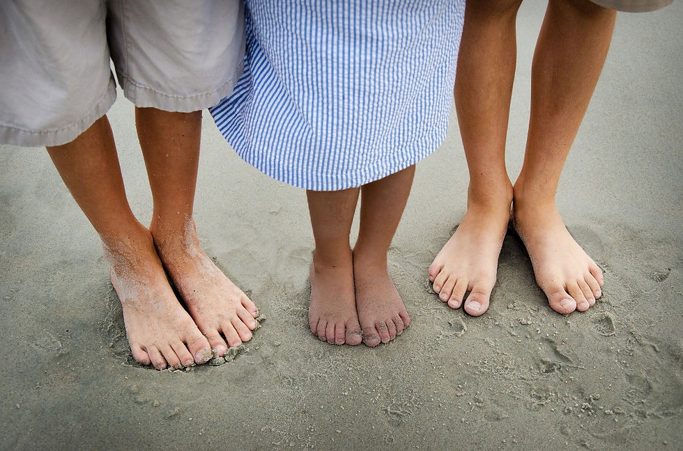 A diverse group of adults and teens in a support group for biological children of adoptive parents.