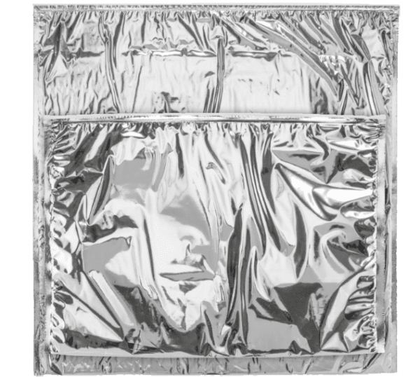 Picture of a silver thermal foil pouch that is sealed and sitting on a white table.