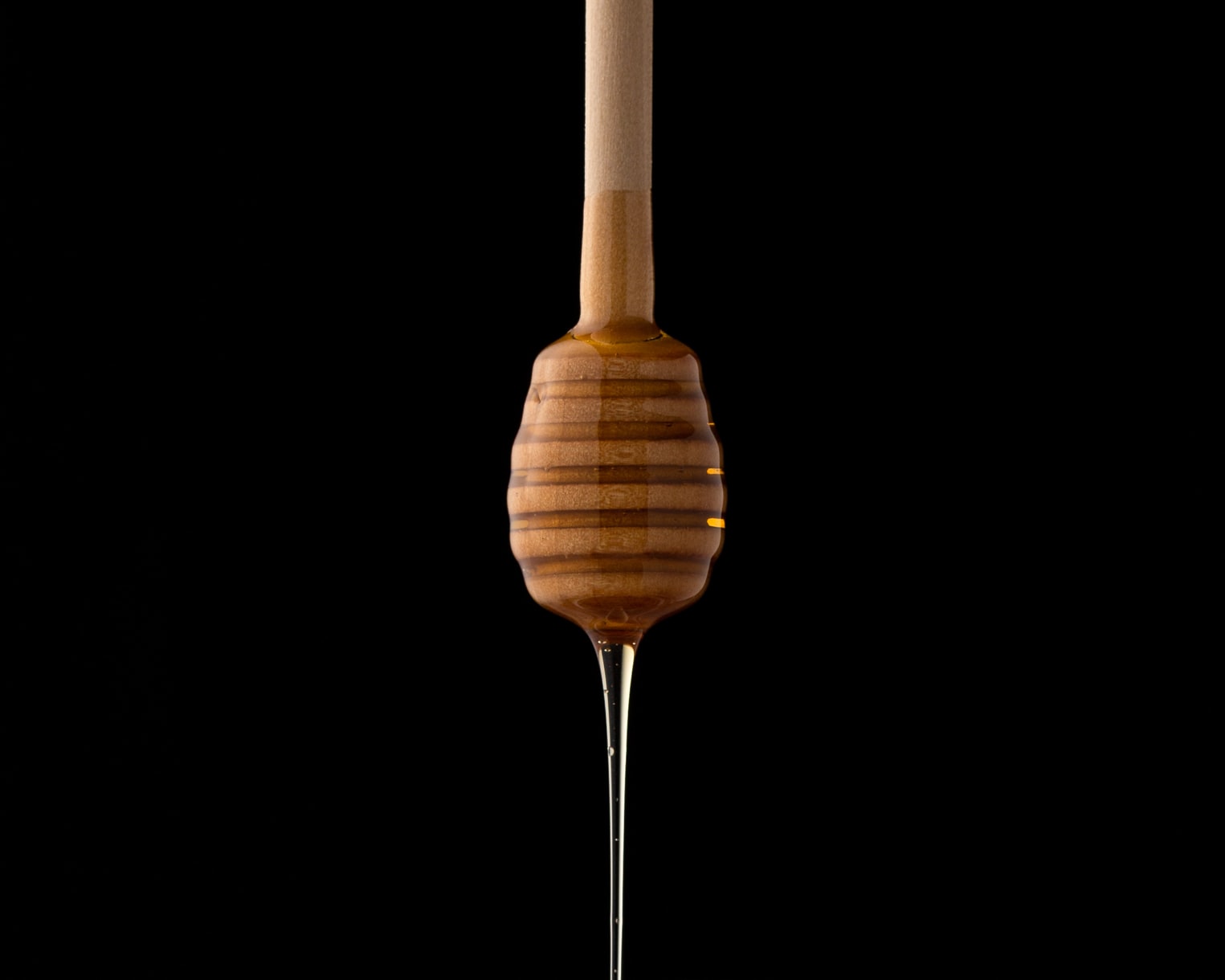 Honey in a jar with a dipper