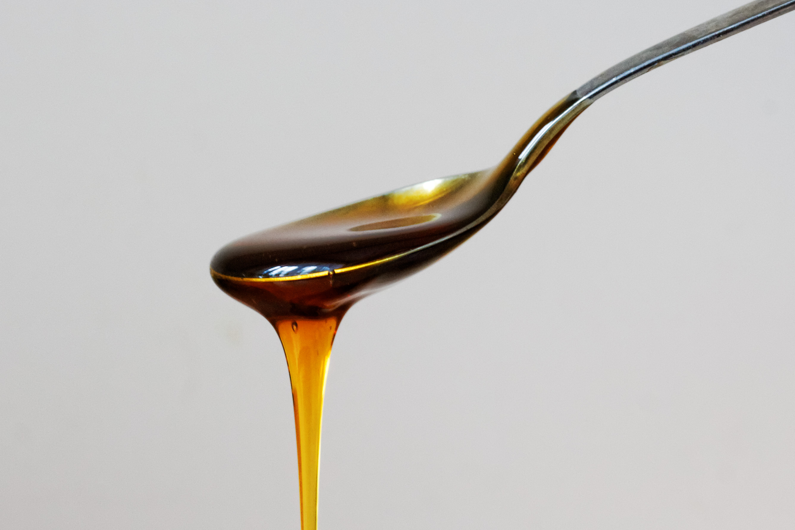Raw honey being poured