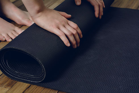 close-up-of-young-woman-rolling-her-fitness-mat-2021-08-28-23-15-25-utc.jpg