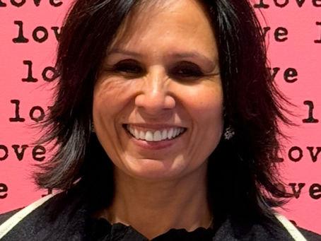 Image of Claire, ECL Volunteer set against a pink background with the words  'love' repeated