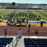 Marching band rehearsing on field, 'PLEASE DO NOT STAND ON OR CLIMB'.