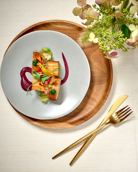 Artistic vegetable dish plated with beet purée and micro-greens on soft beige setting captured by Washington DC food photographer Peggy Cormary for Ridgewell catering.