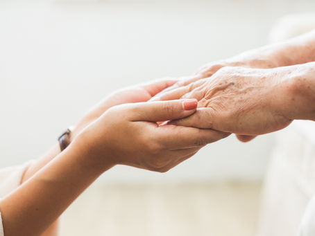A woman's hands holding a loved one's hands