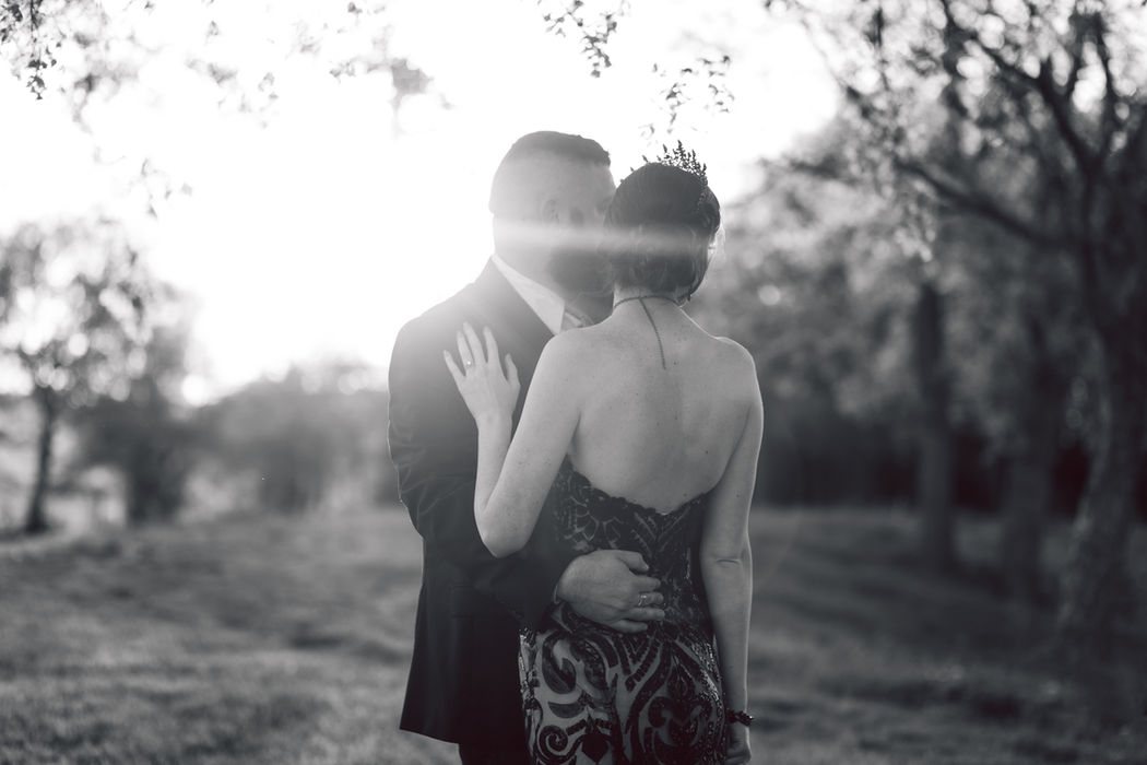 black and white bride with black dress and groom looking far away