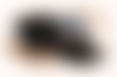 Rice cooker donabe with a brown base, open lids beside it; one is striped blue. Background features a watercolor texture.