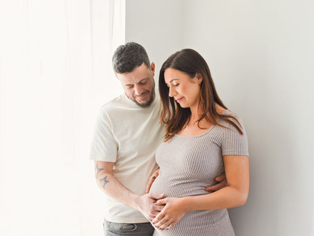 Maternity portrait showing baby bump in neutral tones photographed in Eastbourne