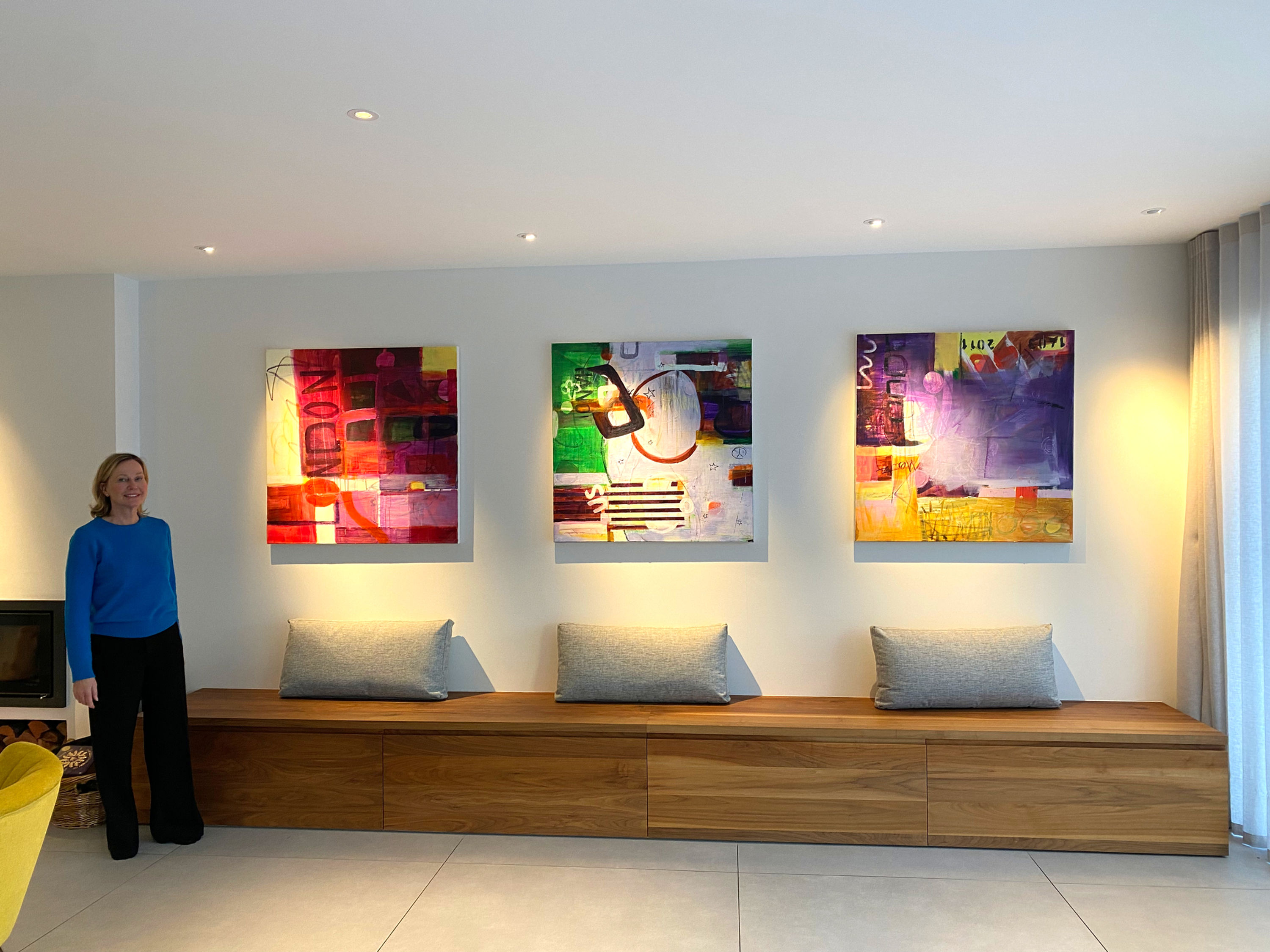 Artist in front of own artwork