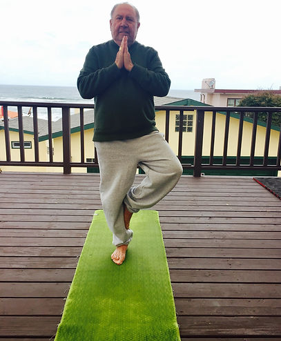 Yoga posing on deck with ocean view