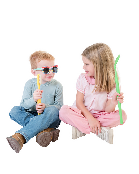 Little boy with sunglasses and little girl playing with large dental tools
