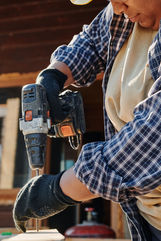 Person drilling wood with power drill