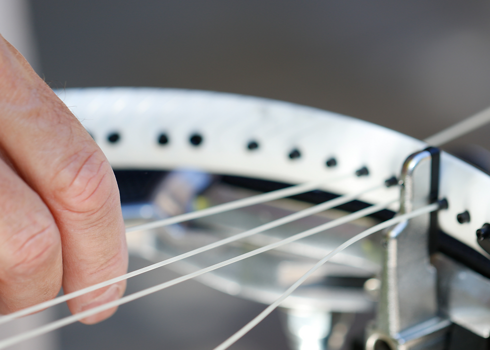 Hand stringing a tennis racquet