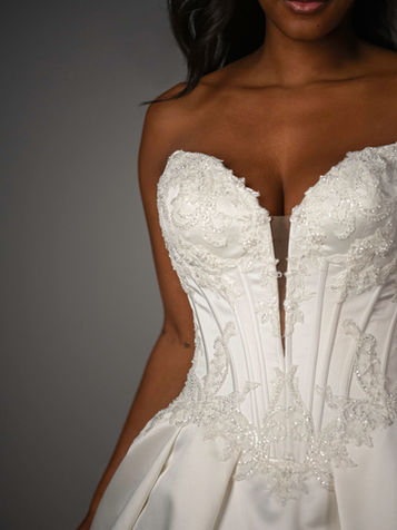 Fashion-forward minimalist bridal gown with sculpted basque corset bodice in San Antonio boutique