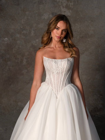 Elegant basque wedding dress with lace and ballgown skirt — available at Bridal Galleria of Texas in San Antonio.