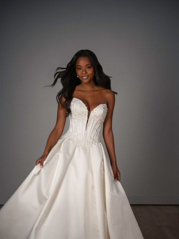 Fashion-forward minimalist bridal gown with sculpted basque corset bodice in San Antonio boutique