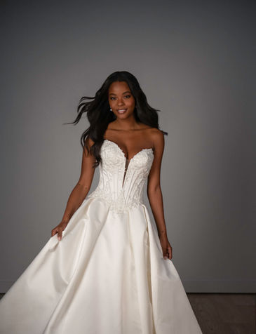 Fashion-forward minimalist bridal gown with sculpted basque corset bodice in San Antonio boutique