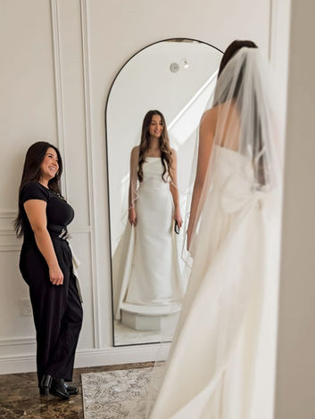 Beautiful bride trying on wedding dresses in San Antonio, TX bridal shop.