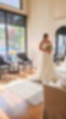 Real bride admiring herself in a wedding dress with overskirt in San Antonio, TX bridal shop