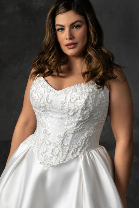 Timeless plus size wedding dress with basque waist, photographed at Bridal Galleria of Texas in San Antonio.