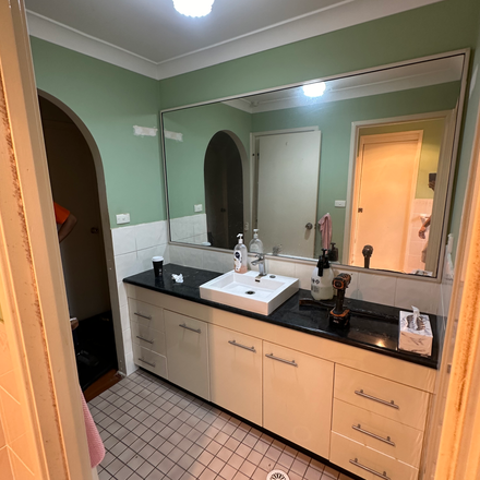 a bathroom with two sinks and a large mirror