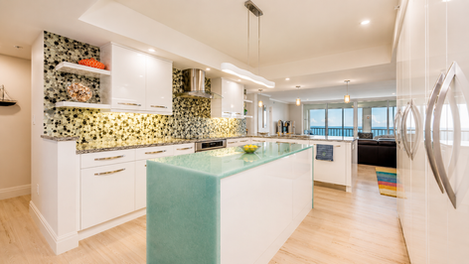 Modern Pelican Bay kitchen with glass island and ocean view