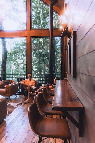 At Hidden Lake Treehouses in Cherry Log, GA, you can elevate your perspective in a unique way. These award-winning vacation homes, designed by architect James Knight of Reynard Custom Homes, are not your typical retreat. Winner of the Atlanta Home Magazine Georgia Design Awards for Best Residential New Build (up to 4,000 sq ft), these modern rustic treehouse-style homes immerse you in the North Georgia mountains. With their stunning floor-to-ceiling windows, outdoor firepits, and ample space for the kids, these homes offer a truly unique experience.