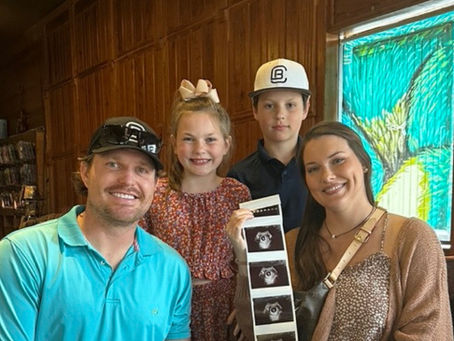 The Taylor family expecting a baby on the way after designing their dream home with Reynard Custom Homes. 