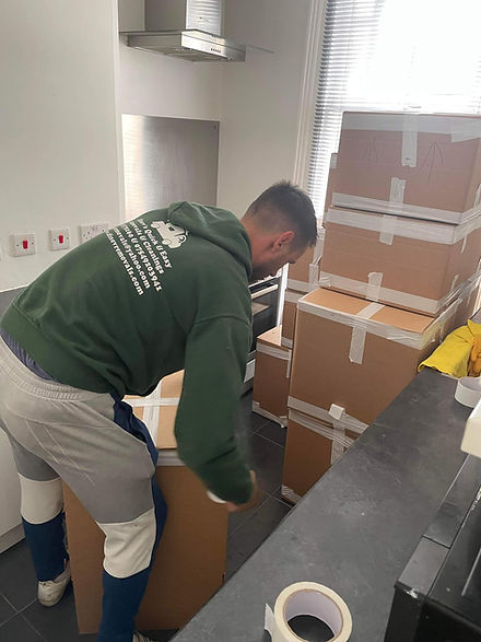 Professional mover stacking cardboard boxes in Hornchurch