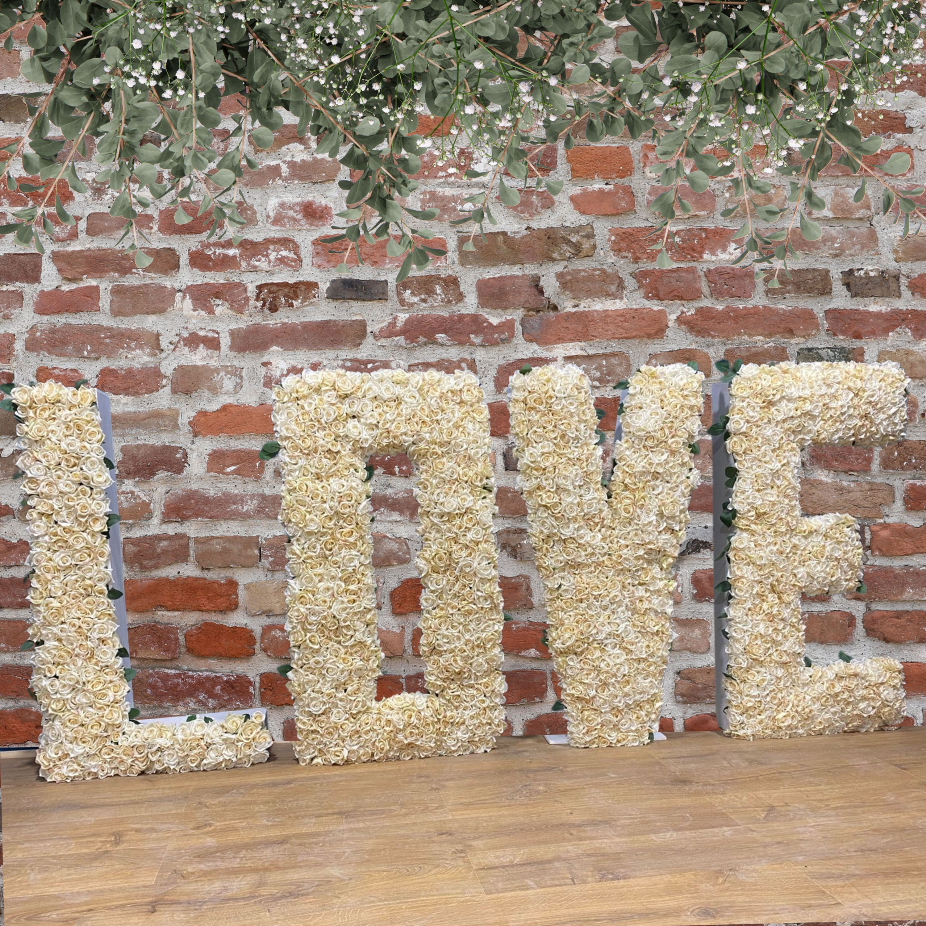 An image capturing the exquisite Floral LOVE Letters available for wedding decor, adorned with vibrant flowers