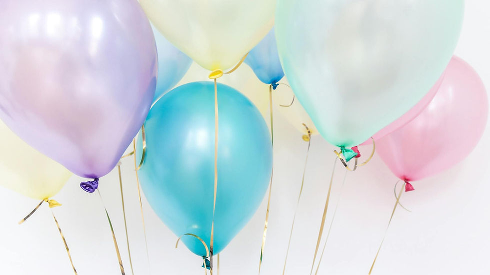 Pastel balloons floating against a neutral background, perfect for festive events.