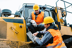 Worker sitting on heavy excavation machi