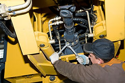 repairman worker screwing nuts of axle a