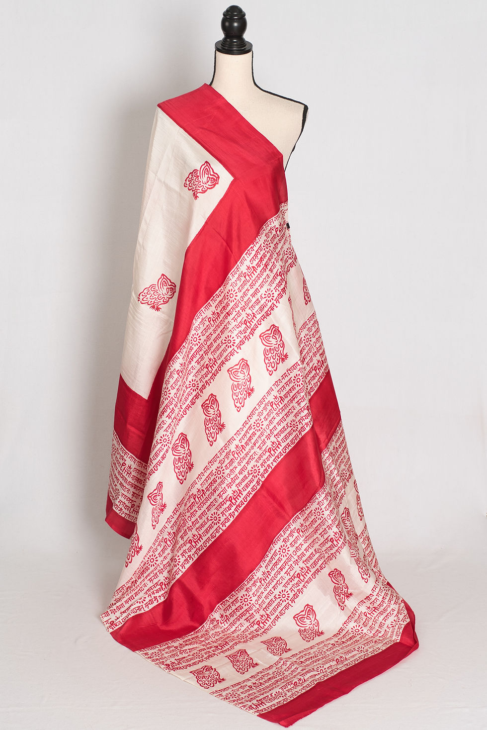 Traditional white and red Murshidabad silk saree featuring red hand block printed owl motifs and Sanskrit chant borders.