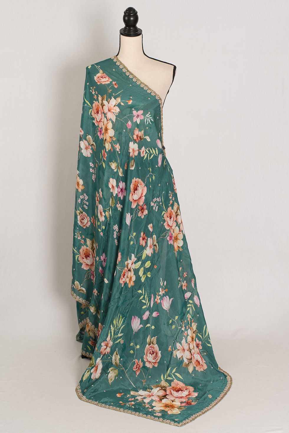 Full-length view of the Afrin teal floral Chinon crepe saree on a mannequin, showcasing the soft drape and pearl border.